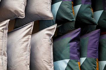 Multi-colored down soft pillows are shot close-up.