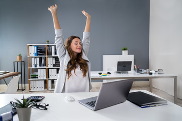 Businesswoman Stretching At Desk