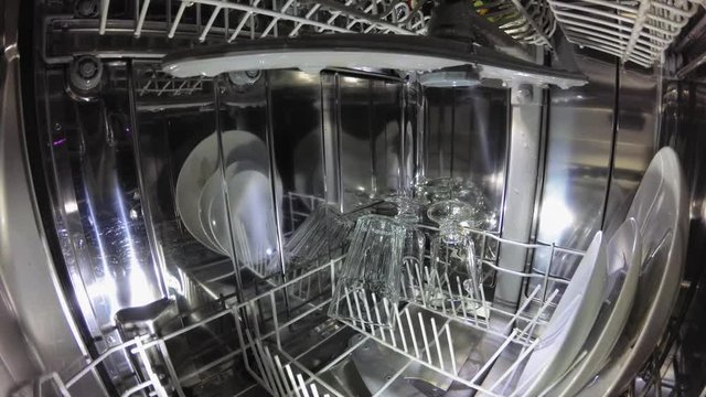 Dishwasher Interior During Washing Dishes and Glasses POV