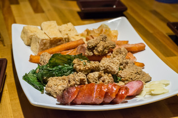 Chinese dinner with tofu, pork and fish