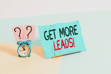 Conceptual hand writing showing Get More Leads. Concept meaning initiation consumer interest or enquiry products or services Alarm clock beside a Paper sheet placed on pastel backdrop