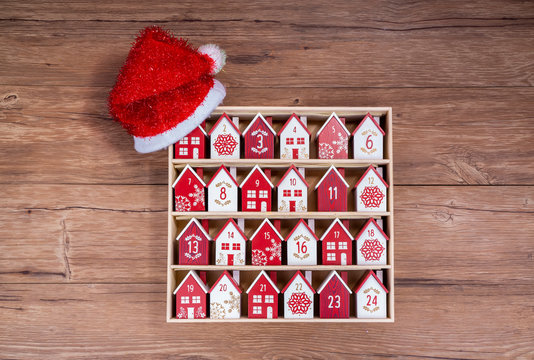 handmade wooden perpetual calendar in a form of a house with christmas hat