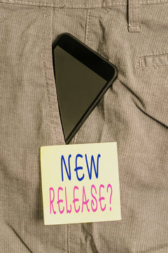 Word writing text New Release Question. Business photo showcasing asking about recent product or service newly unleashed Smartphone device inside formal work trousers front pocket near note paper