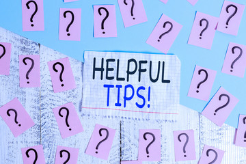 Conceptual hand writing showing Helpful Tips. Concept meaning advices given to be helpful knowledge in life Crumbling papers with thick cardboard on the wooden table