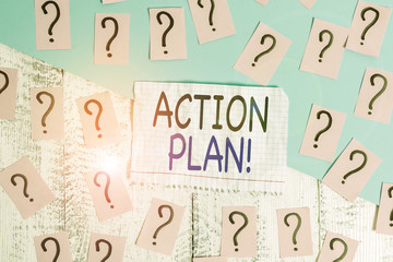 Conceptual hand writing showing Action Plan. Concept meaning proposed strategy or course of actions for certain time Crumbling papers with thick cardboard on the wooden table