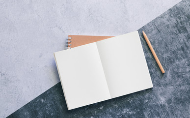 Top view of white binder blank notebook or diary or journal for writing text and message with pencil on concrete background with copy space. Minimalism lifestyle of business and education concept.