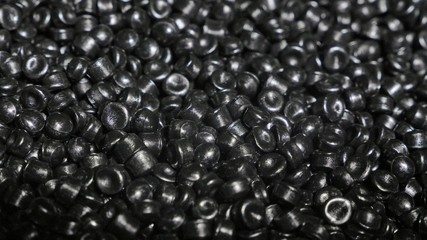 Plastic black gray granulated crumb. Manufacture of plastic water pipes of the factory. Process of making plastic tubes on the machine tool with the use of water and air pressure.