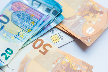 Euro money with credit card on white background