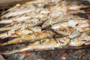 Grill fish on a stove that uses charcoal as fuel for grilling