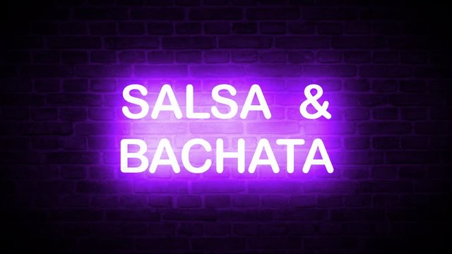 A high quality video of a neon sign that reads: Salsa & Bachata