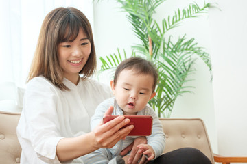 スマートフォンを使う赤ちゃんとお母さん