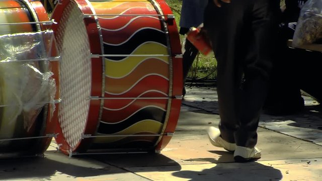 Bolivian Musician throwing Beer on the Drums of the Musical Band, offering for the Pachamama before Playing. Filmed in La Paz, Bolivia. 
