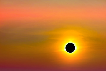 phenomenon of total sun eclipse over silhouette orange cloud and sunset sky