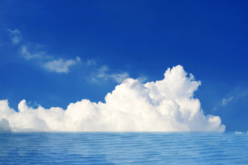 reflection white pure heap cloud in the blue sky and sunlight on sea surface