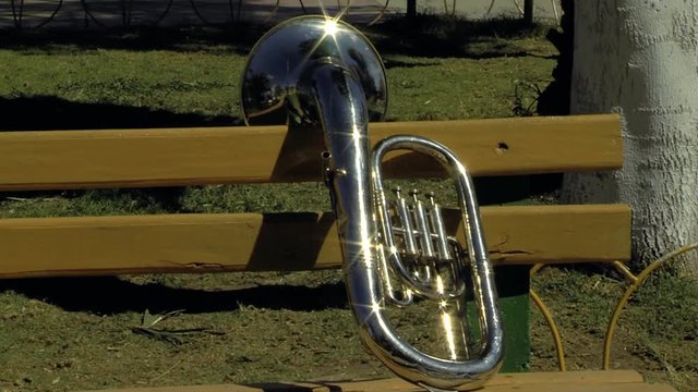 A Baritone Horn over a Park Bench. Zoom In. 