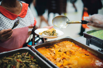 Homeless people receive free food from compassionate people: the concept of food needs