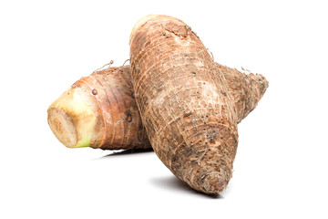 Two Taro root stacked together on a white background.