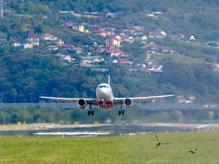 The plane takes off into the blue sky. Airport. Bottom view. The commercial airlines. Air service.