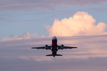 The plane takes off into the blue sky. 