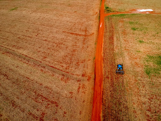 Aerial view of a tractor harrowing the soil to plant soybeans in Brazil