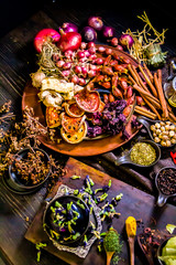 Top view Thai spices and herbs ingredient decoration on wood table for cook in home kitchen. 