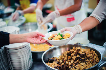Beggars receive warm and delicious food from the donor's hands: the concept of food beggars