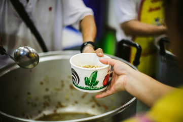 Beggars receive warm and delicious food from the donor's hands: the concept of food beggars