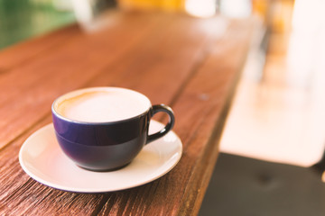 cup of coffee on wooden table