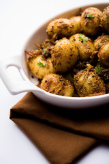 Jeera Aloo - Potatoes Flavoured With Cumin seeds and spices. popular Indian main course recipe. served in a bowl. selective focus