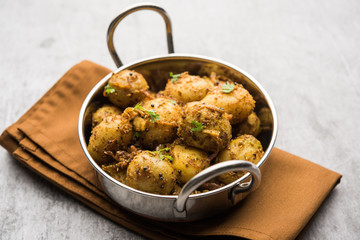 Jeera Aloo - Potatoes Flavoured With Cumin seeds and spices. popular Indian main course recipe. served in a bowl. selective focus