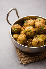 Jeera Aloo - Potatoes Flavoured With Cumin seeds and spices. popular Indian main course recipe. served in a bowl. selective focus