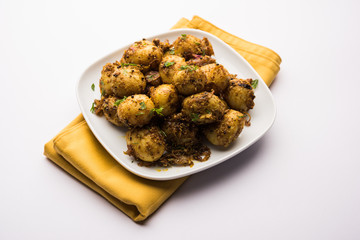 Jeera Aloo - Potatoes Flavoured With Cumin seeds and spices. popular Indian main course recipe. served in a bowl. selective focus