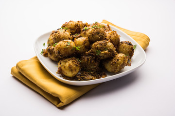 Jeera Aloo - Potatoes Flavoured With Cumin seeds and spices. popular Indian main course recipe. served in a bowl. selective focus