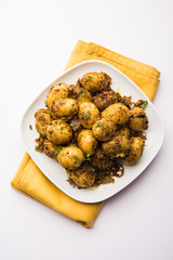 Jeera Aloo - Potatoes Flavoured With Cumin seeds and spices. popular Indian main course recipe. served in a bowl. selective focus
