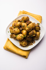 Jeera Aloo - Potatoes Flavoured With Cumin seeds and spices. popular Indian main course recipe. served in a bowl. selective focus