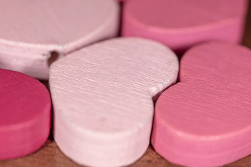 Pink wooden hearts as a background