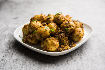Jeera Aloo - Potatoes Flavoured With Cumin seeds and spices. popular Indian main course recipe. served in a bowl. selective focus