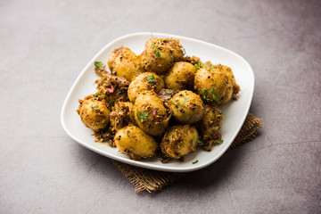 Jeera Aloo - Potatoes Flavoured With Cumin seeds and spices. popular Indian main course recipe. served in a bowl. selective focus