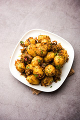 Jeera Aloo - Potatoes Flavoured With Cumin seeds and spices. popular Indian main course recipe. served in a bowl. selective focus