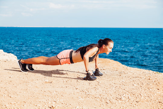 woman goes in for Sports Fitness on the beach - Powered by Adobe