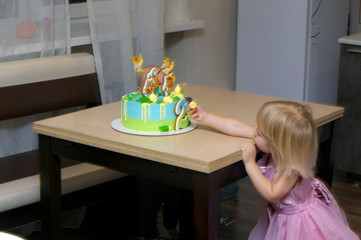 Little girl enjoying her birthday cake with candy