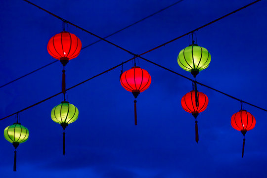 traditional chinese lanterns. Bright holiday in China in Asia New Year. Bright multi-colored paper lanterns on dark blue evening sky background 