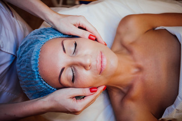 doctor cosmetologist doing facial massage girl spa