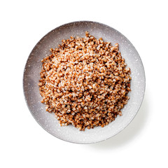 Tasty and healthy buckwheat porridge with butter isolated on white background.