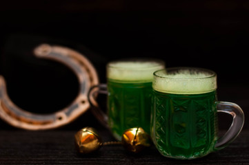 St. Patrick Day concept. Glasses of green beer. On wood dark table