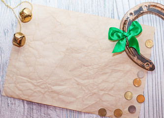horseshoe, coins and bells on a light wooden table. A symbol of good luck. blank for designers