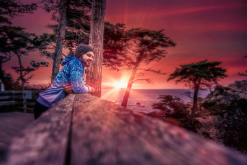 Young man in his twenties deep in thought; sunset in Monterey, California USA.