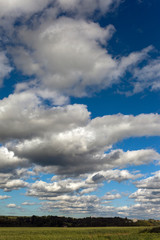 Big clouds over green land.