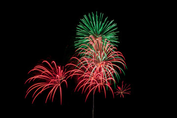 Multicolored bright festive fireworks in the dark sky background.Beautiful colorful fireworks for celebration holiday concept. 