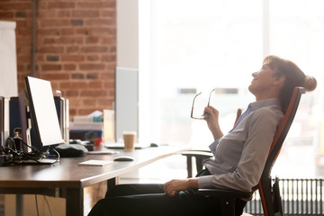 Side view relaxed businesswoman resting leaning on comfortable office chair
